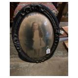 Antique photograph in oval wood frame with bubble