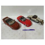 Three diecast cars, including a Pontiac f