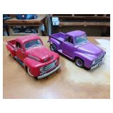Two diecast model trucks, one a red 1948 F1 Ford