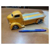 Yellow Jada diecast model of a 1947 Ford Coe