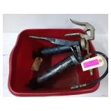Two grease guns in a red tub