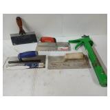 Concrete trowels, and a green caulk gun