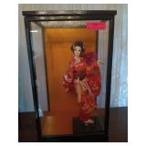 Porcelain Asian figurine in glass display case