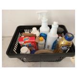 Black shopping basket full of cleaning supplies