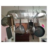 Contents hanging from pot rack: skillets,