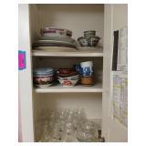 Cabinet contents: plates, bowls, small vases,