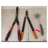 Two pair of loppers and a hand tiller
