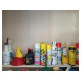 Shelf of assorted cleaners, lawn mower oil, mole