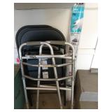 Two black metal folding chairs, one walker, and a