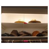 Two shelves of hats, includes Irish hats,