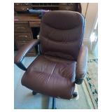 Brown office rolling chair, kind of rough, and a