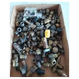 Flat full of assorted fittings, mostly brass