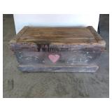 Old wooden trunks with heart painted on back,