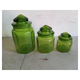 Three Green Glass canisters with lids, have some