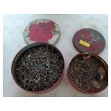 Two Christmas tunes filled with assorted nails,