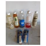 Five assorted used bottles of lamp oil with two