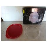 Two 13 in cookie trays, one is red plastic, one is