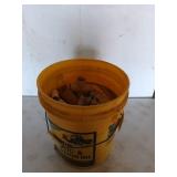Yellow 5 gallon bucket filled with assorted PVC