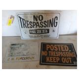 Three signs, two are aluminum, "no trespassing" is