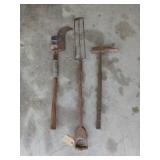 Three old yard tools, including a repaired sling