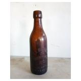 Thick brown glass bottle marked E.L Husting