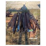 Pile of assorted post and rods 4 to 6 ft