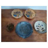 Three ashtrays, one is from germany, one is made