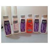 Six bottles of VO5 shampoo/conditioner, most