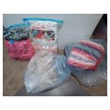 Four bags filled with blankets/pillows, etc