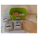 Green tote filled with drapes / curtains, some are