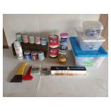 Assorted paints, stains, painting supplies, and