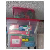 Two storage containers filled with ornaments /