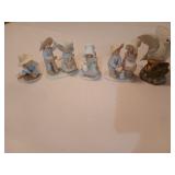 Four Circle of Friends figurines, one has been