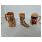 Three assorted steins, one is Alaska, one is