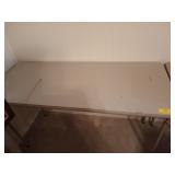 Skinny folding table, top has some damage,