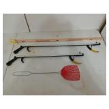 Two brooms, a mop, a yard stick, two grabbers, a