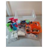 Tub filled with assorted spray bottles, shoe