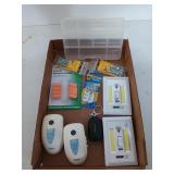 Earplugs, a plastic organizer, stick on lights,