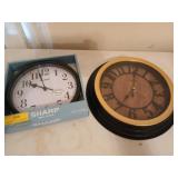 Two Sharp wall clocks, 9 and 13 in, one is new i