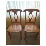 Pair of blonde-colored wooden dining chairs, has