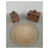 Two butter molds and a wooden cutting board for