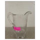 Clear glass pitcher with pedestal foot and rick-