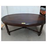 Dark wooden oval coffee table, with bamboo like