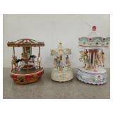 Three carousel music boxes, two are battery
