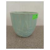 Turquoise colored flower pot with flower motif,