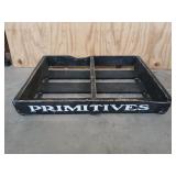 Black wooden display crate, marked "primitives",