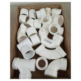 Box of assorted PVC couplings, 1.5 in