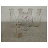 Five glass one quart milk bottles and a 1/3