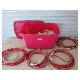 Red storage tub filled with Christmas lights