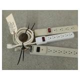 Three surge protector power strips, two are 3 ft